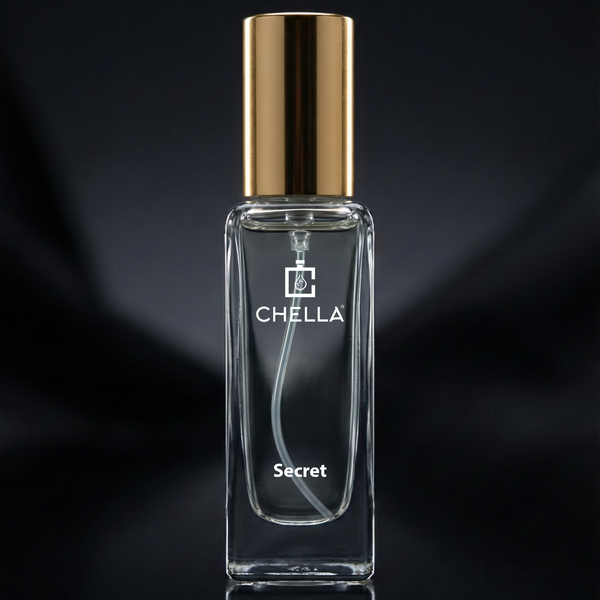 Clear perfume bottle with gold cap on a black background