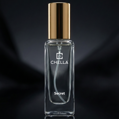 Clear perfume bottle with gold cap on a black background