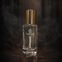 Clear glass bottle with gold cap labeled 'Chella Darkwood' on a dark background