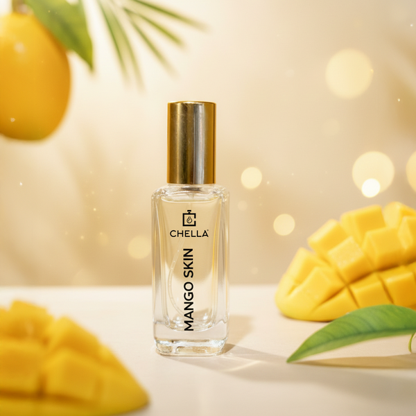 Chella Mango Skin perfume bottle with mangoes and leaves on a light background